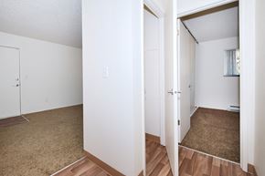 Beaverton apartment for rent - the living room and bedroom of an apartment with wood flooring and white walls