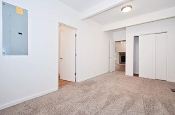 Beaverton apartment for rent - a living room with carpet and white walls and doors