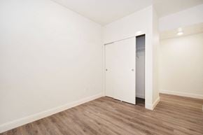 Burlingame apartment for rent - a bedroom with white walls and wood flooring and a closet
