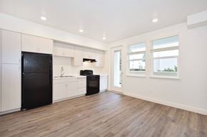Burlingame apartment for rent - a kitchen with white cabinets and a black refrigerator