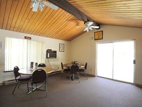 Ontario apartment for rent - A room with a wooden ceiling and a table with chairs.