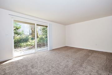 Gresham apartment for rent - a living room with carpet and a sliding glass door