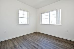 Oroville apartment for rent - a bedroom with two windows and a hardwood floor