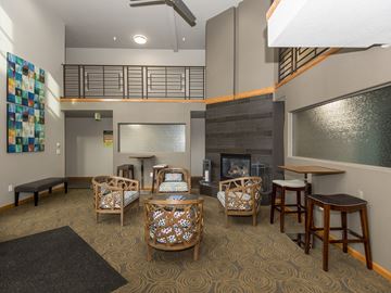 Gresham apartment for rent - a living room with a fireplace and tables and chairs