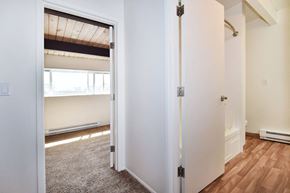Beaverton apartment for rent - a bedroom with a medium sized bed and a closet with a mirrored door