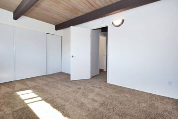 Beaverton apartment for rent - a living room with white walls and carpet and a door to a closet