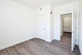 Chico apartment for rent - a bedroom with white walls and wood flooring and a closet