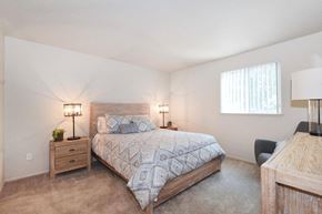 Vancouver apartment for rent - a bedroom with a bed and two lamps