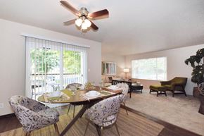 Vancouver apartment for rent - a dining room with a table and chairs and a ceiling fan