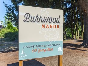 Woodburn apartment for rent - a sign that reads in front of trees