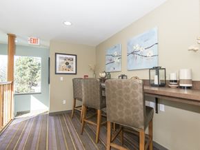 Portland apartment for rent - a dining area with two chairs and a bar with a counter and a window
