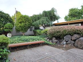 Milwaukie apartment for rent - a bench in a garden in front of a house