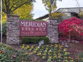 Tualatin apartment for rent - a sign that says meridian village with a red tree in the background