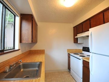 Lincoln City apartment for rent - a kitchen with a sink and a stove and a refrigerator
