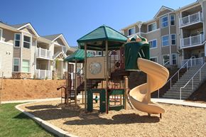 Oroville apartment for rent - a playground with a slide in front of an apartment building