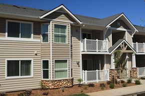 Oroville apartment for rent - an apartment building with tan siding and a balcony