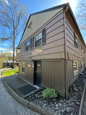 Portland apartment for rent - A building with a brown siding and a black door.