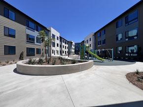 Bay Point apartment for rent - A playground with a slide is in front of a building.