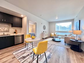 Bay Point apartment for rent - A modern kitchen with a yellow chair and a dining table.