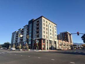 Concord apartment for rent - A street view of a multi-story building with a clear blue sky above.