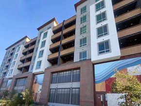Concord apartment for rent - A tall white building with a mural on the side of it.