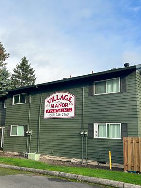 Portland apartment for rent - A green building with a sign that says Village Manor Apartments.
