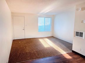 Meridian apartment for rent - an empty living room with a window and a door