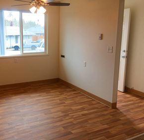 Gladstone apartment for rent - an empty living room with wooden floors and a window