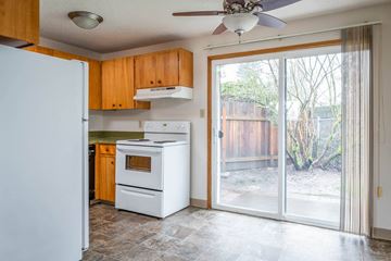 Milwaukie apartment for rent - a kitchen with a white stove and a sliding glass door