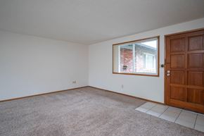 Milwaukie apartment for rent - a bedroom with white walls and a large window