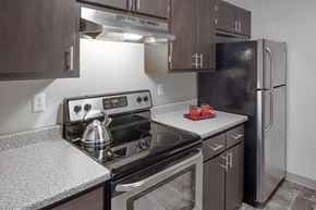 Milwaukie apartment for rent - a kitchen with wood cabinets and stainless steel appliances