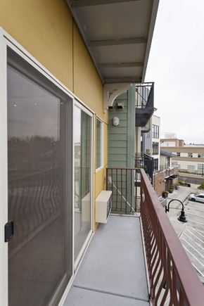 Gresham apartment for rent - A balcony with a metal railing and a glass door.