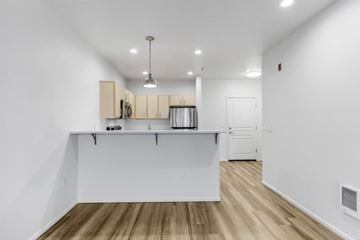 Gresham apartment for rent - A kitchen with white cabinets and a white island.