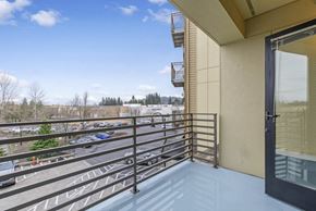 Gresham apartment for rent - A balcony with a metal railing and a glass door.