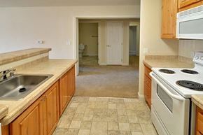 Truckee apartment for rent - a kitchen with white appliances and wooden cabinets