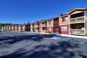 Truckee apartment for rent - an empty parking lot in front of a row of apartment buildings