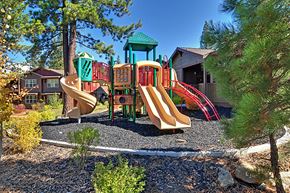Truckee apartment for rent - a playground with slides and other playground equipment in front of a building