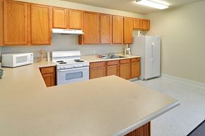 Red Bluff apartment for rent - a kitchen with white appliances and wooden cabinets