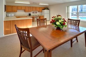 Anderson apartment for rent - a dining room table with a vase of flowers on top of it
