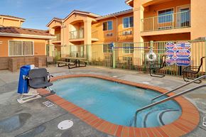 Anderson apartment for rent - a swimming pool with a chair in front of an apartment building