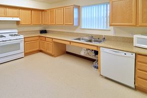Anderson apartment for rent - a kitchen with wooden cabinets and a white stove and sink