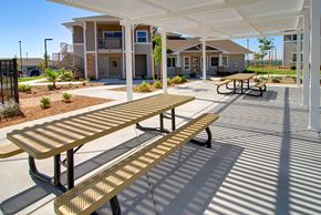 Oroville apartment for rent - a picnic area with benches in front of a building