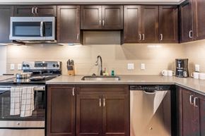 Happy Valley apartment for rent - a kitchen with wooden cabinets and a sink and a microwave