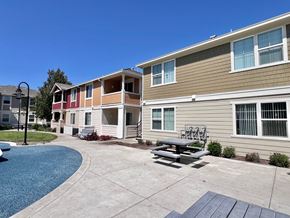 Brentwood apartment for rent - A sunny day at a residential complex with a pool and a picnic table.