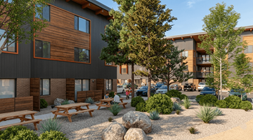 Truckee apartment for rent - A modern building with wooden accents and a landscaped courtyard.