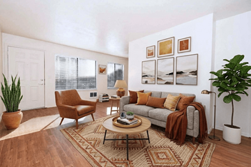 Tigard apartment for rent - A living room with a brown rug and a brown chair.