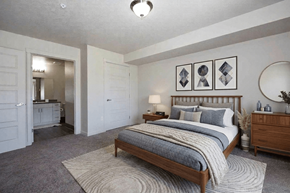 Ridgefield apartment for rent - A bedroom with a large bed and a mirror on the wall.