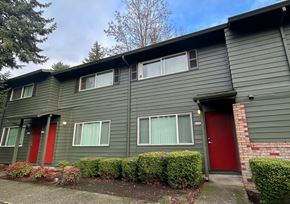Portland apartment for rent - A grey house with red doors and windows.