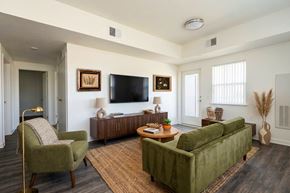Oroville apartment for rent - A living room with a green couch, a chair, and a coffee table.