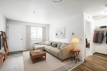 Beaverton apartment for rent - A living room with a couch, a coffee table, and a painting on the wall.